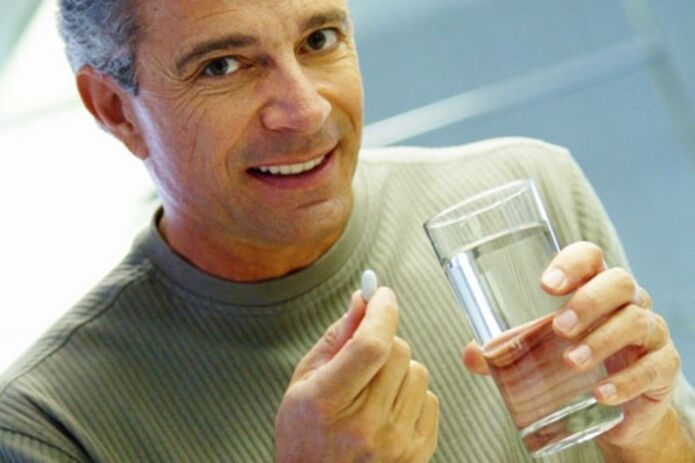 a man takes a tablet to treat prostatitis